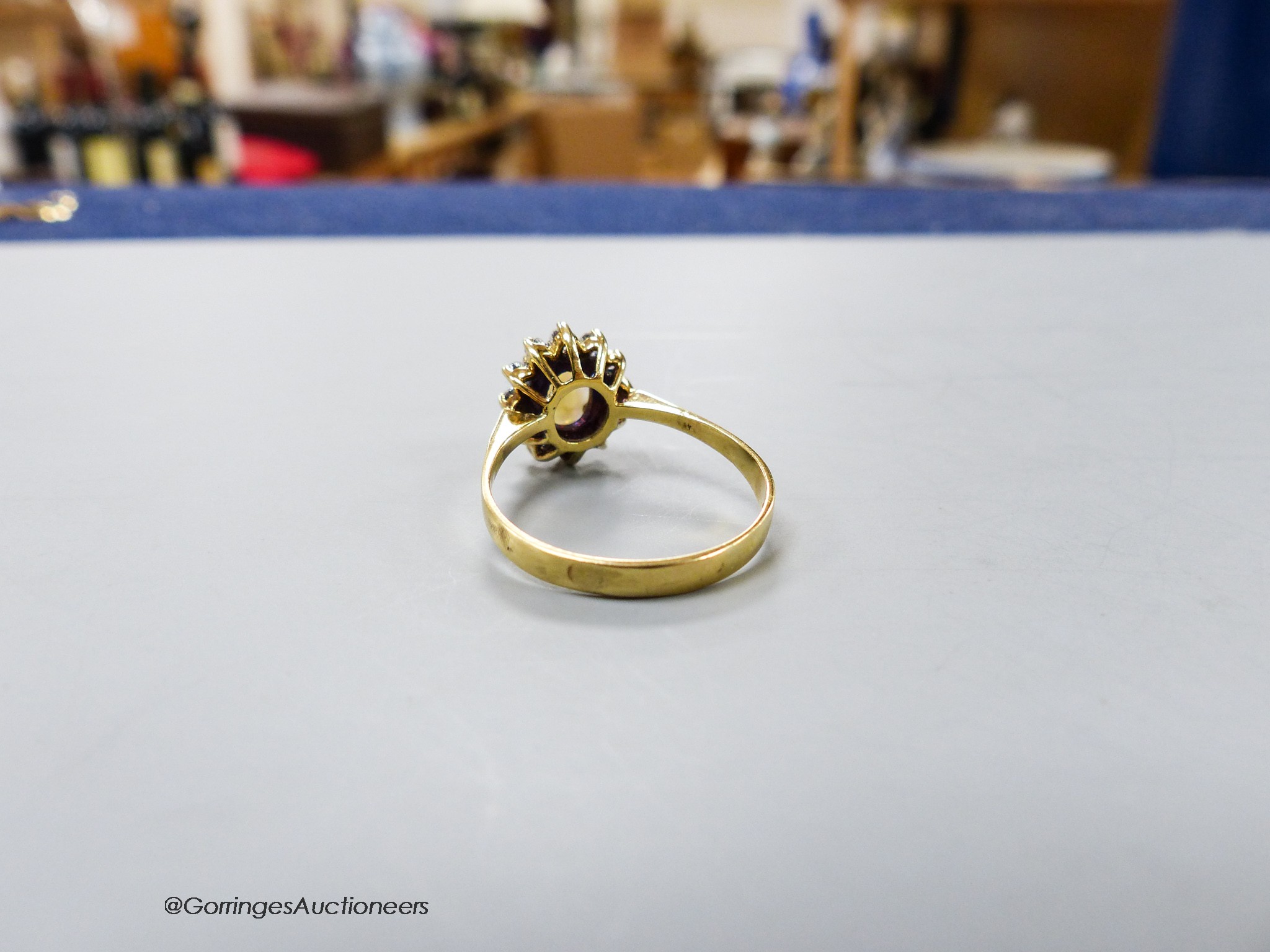 A modern yellow metal, white opal and diamond set oval cluster ring, size S, gross 4 grams.